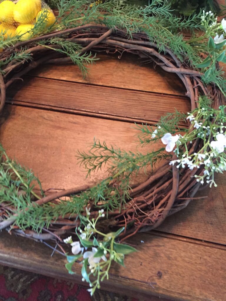 DIY farmhouse wreath: Use small bunches of white flowers threaded through grapevine wreath