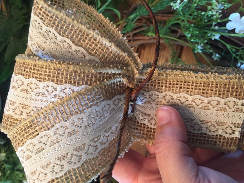 DIY Farmhouse wreath: wrap with wire center notch  of burlap bow